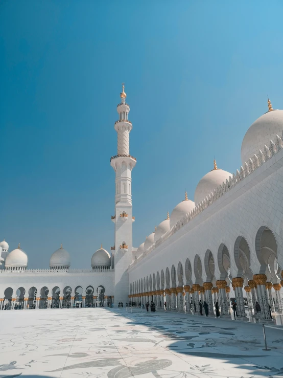 a very big white building with a clock on it