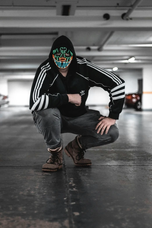 a man with a starbucks mask is squatting down