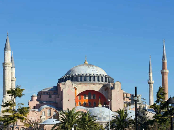 a large building has blue domes and towers