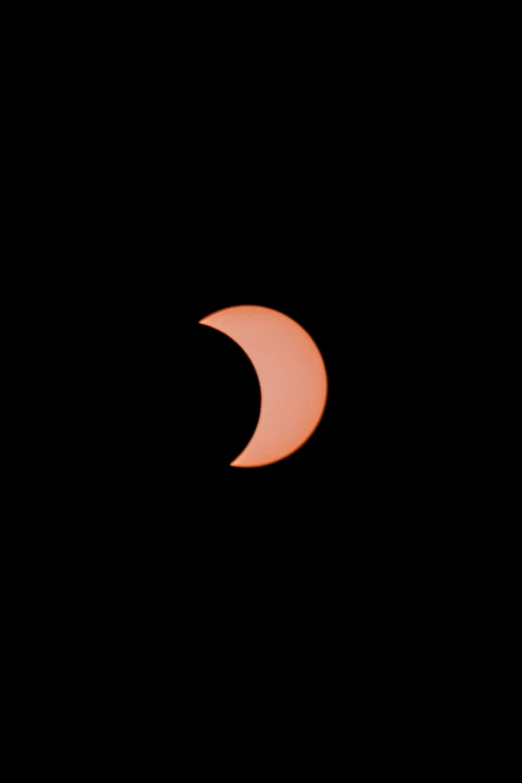 the sun shining behind a partial eclipse in the dark sky