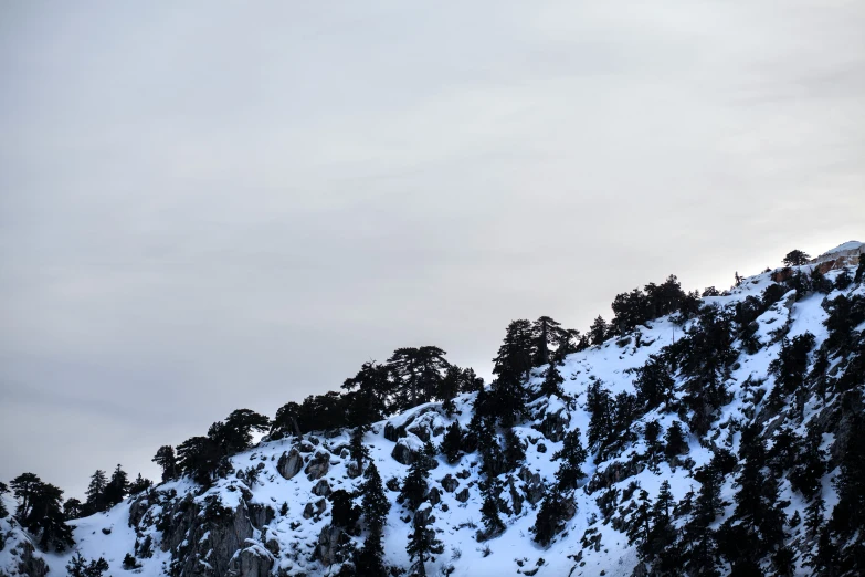 the sky is dark over a snow covered mountain