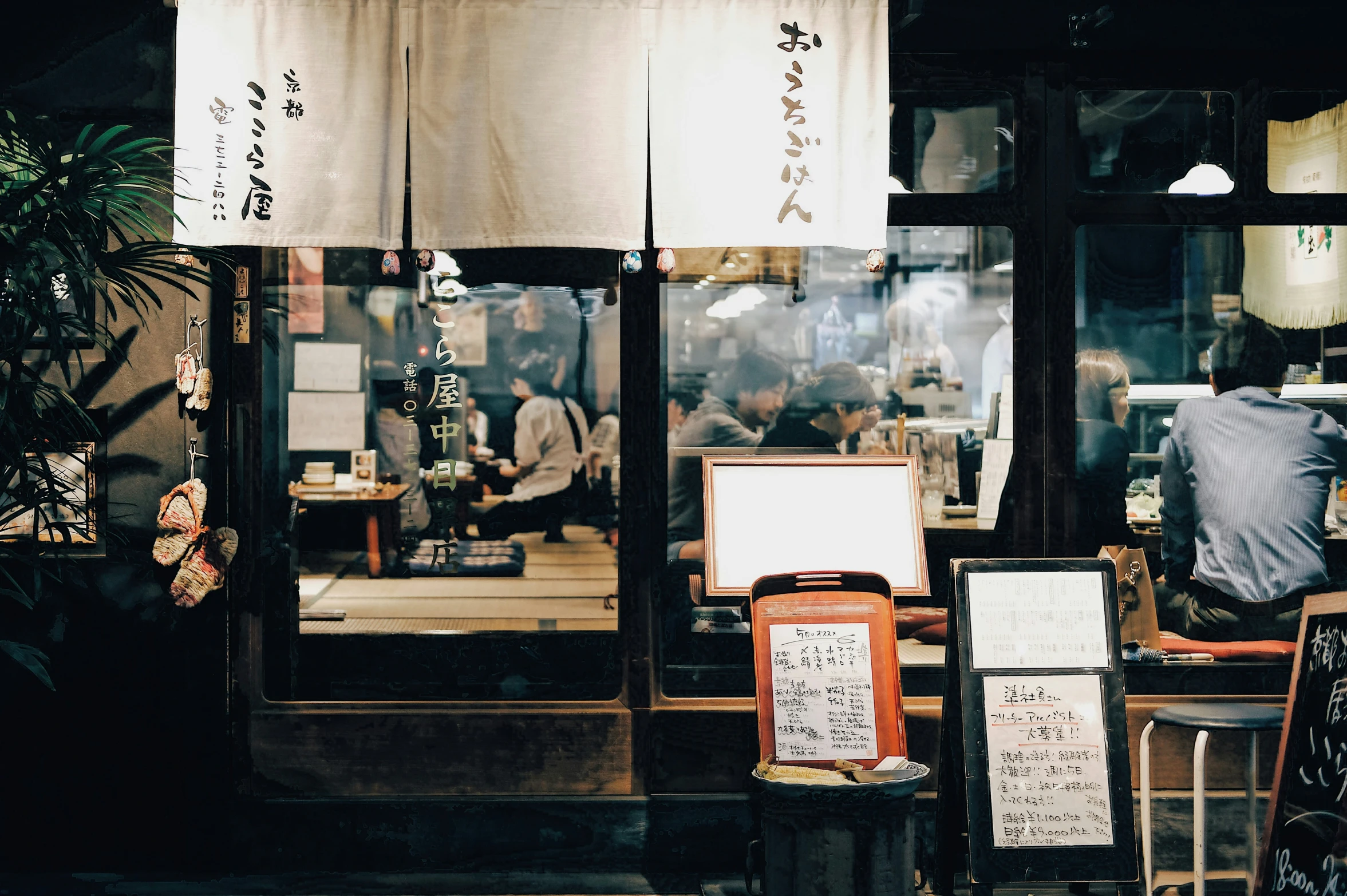 asian food shops with signboards showing their customers