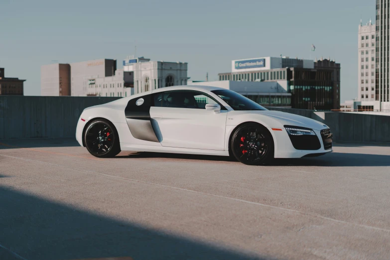 a car parked on the pavement in front of a city