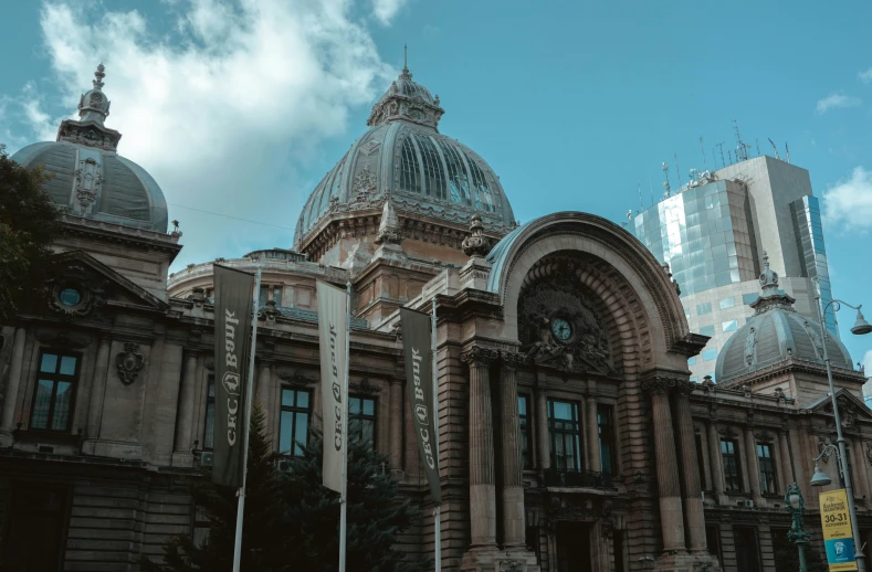 a building with a domed clock tower next to buildings