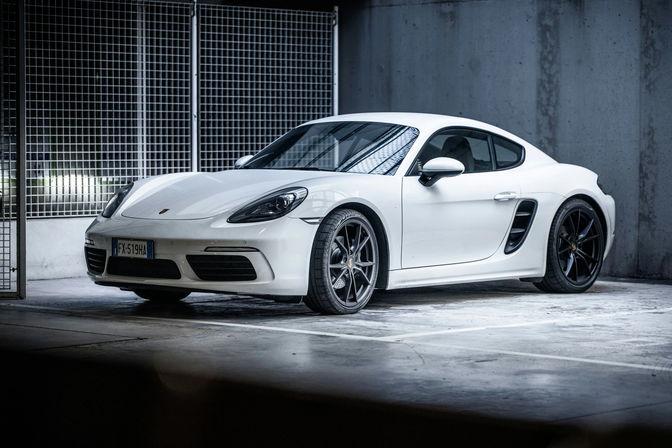 a white sports car parked in the dark