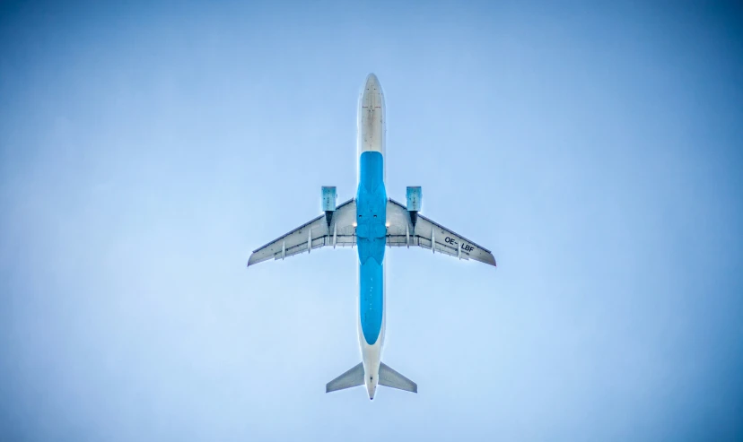 an airplane is flying through the clear blue sky