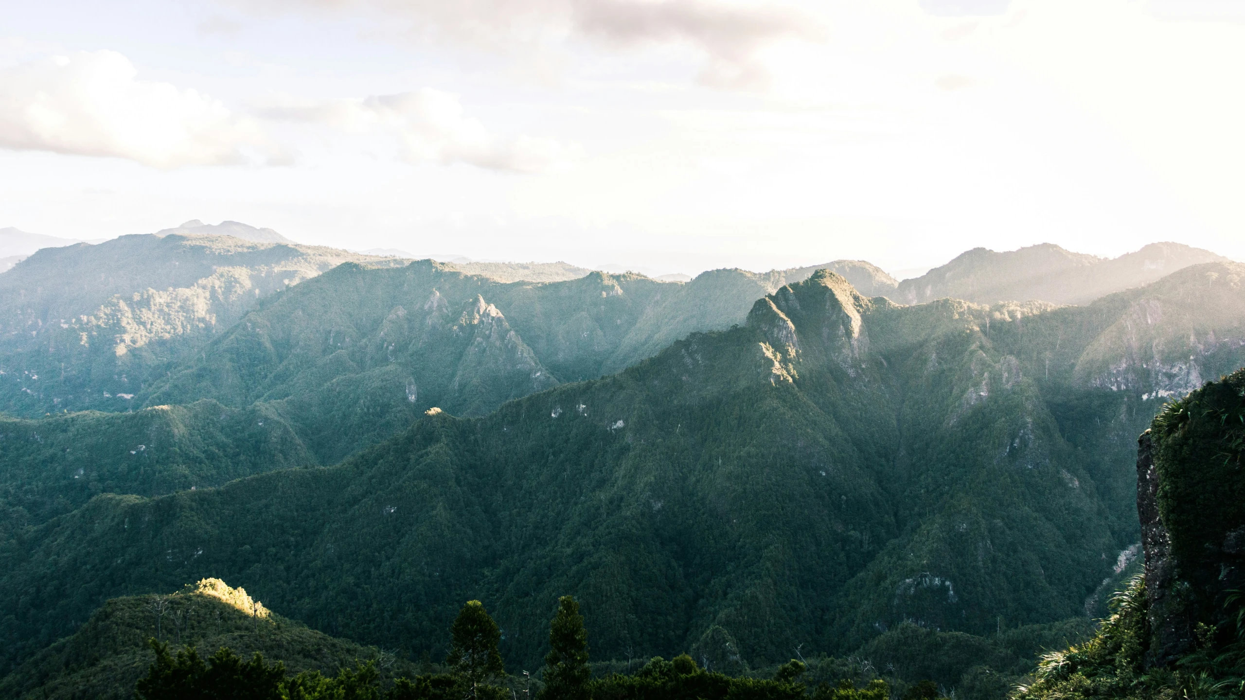 a mountain range with some very big green mountains