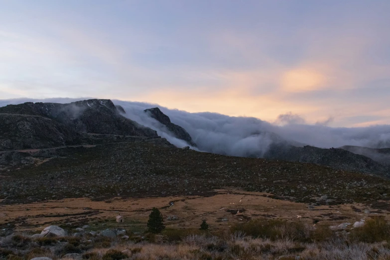 the clouds are covering the mountain peaks in this po