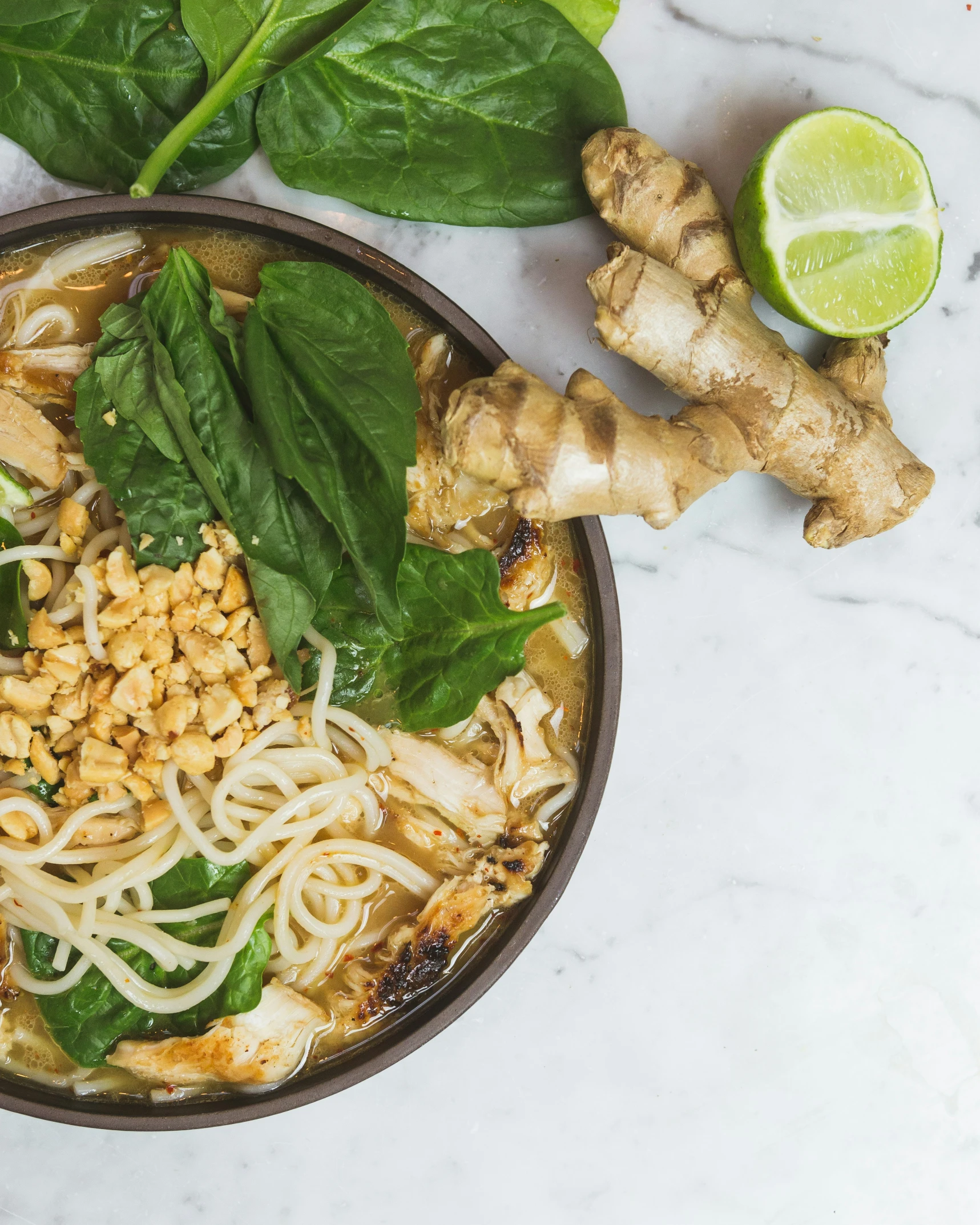 a bowl with a meat and noodle meal is on a table