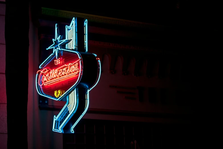 a large sign is lit up with a neon light