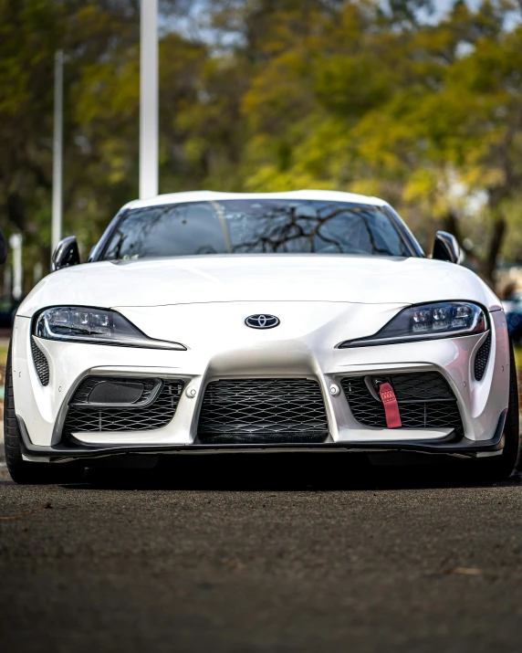 a white sports car sits parked by itself