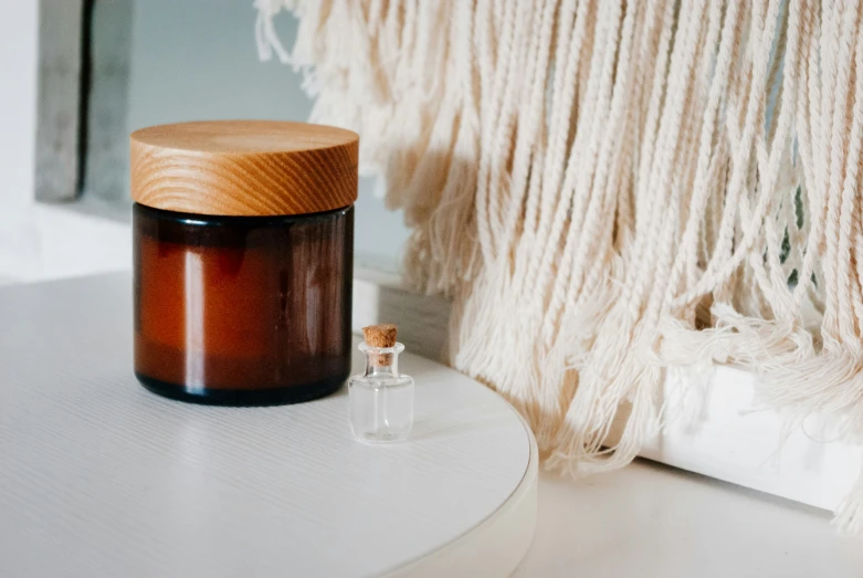 an empty jar sitting on a white table