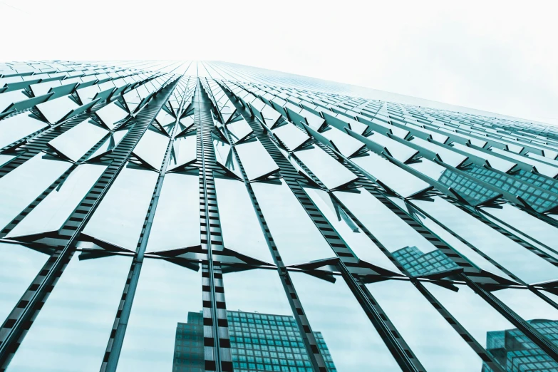 a glass - paneled building with an abstract reflection on the outside wall