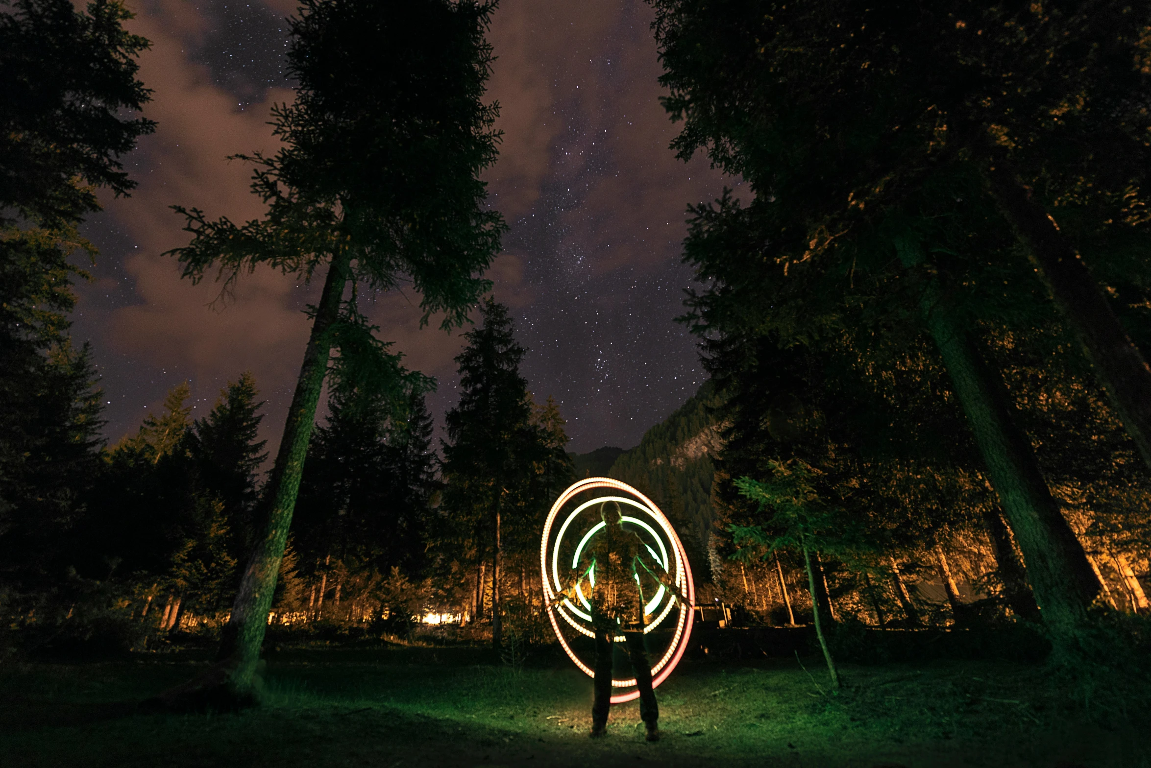 a person holding two lights that are outside