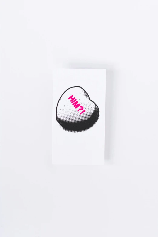 a small hat with pink letters is placed on a white wall