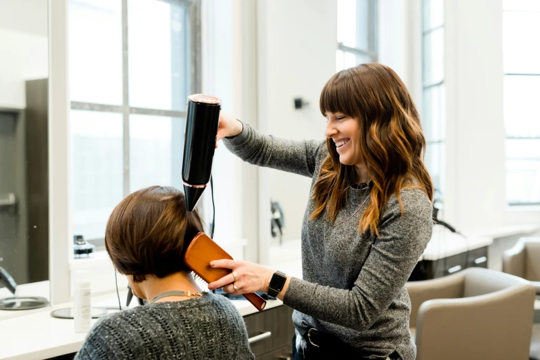 woman having blow dry and hair  from a hair dryer