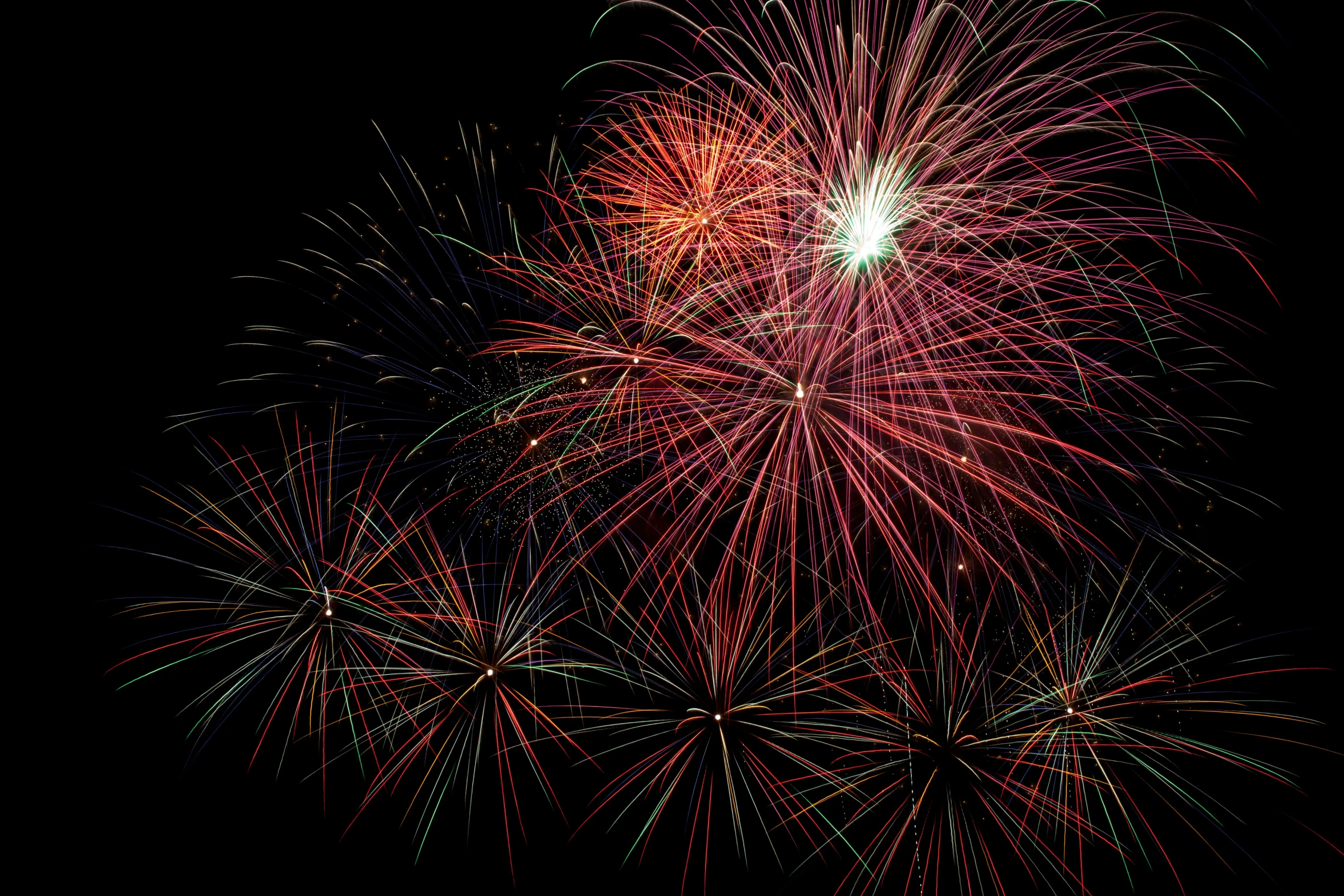 a night view of several brightly lit fireworks