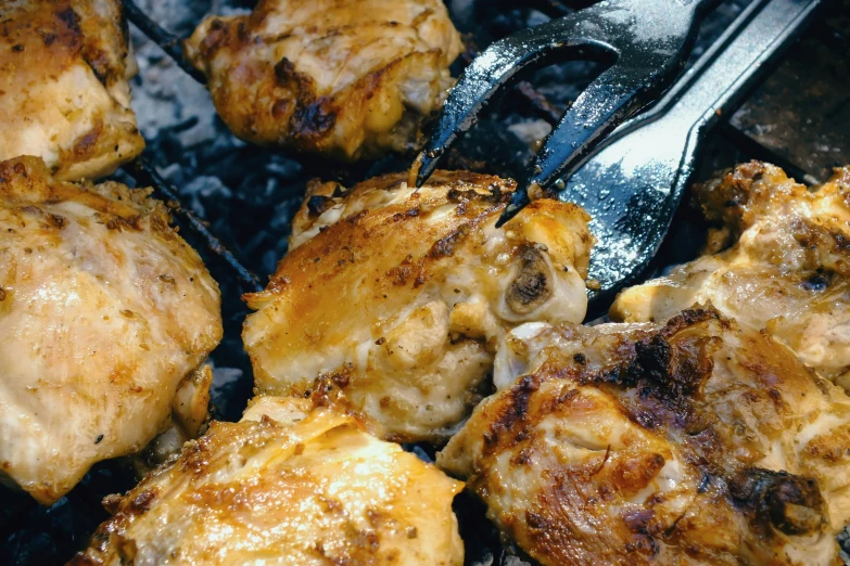 a couple of meats cooking on top of an open grill