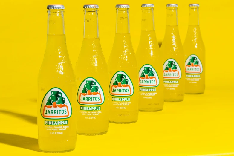 several bottles of beer and some are on a yellow background