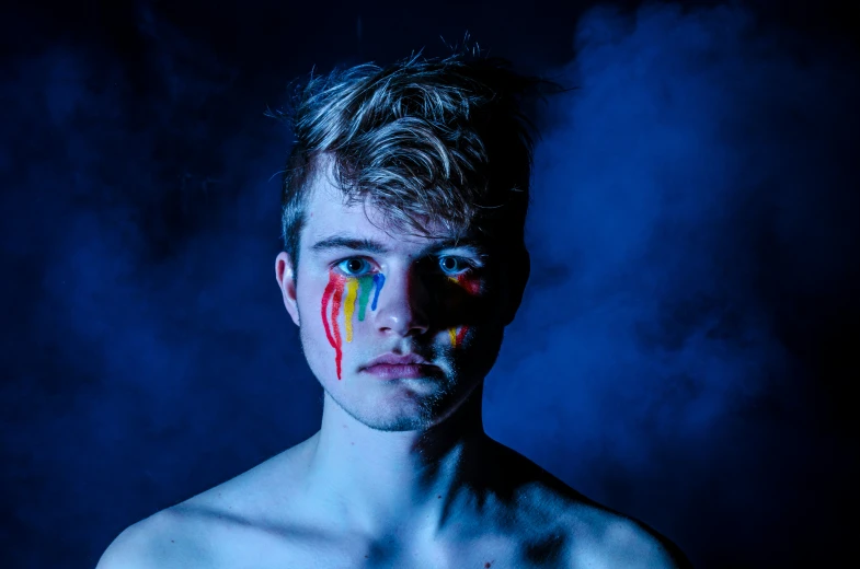 a man with his body painted in bright colors