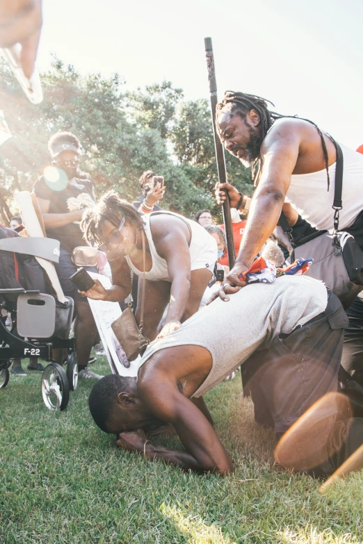 several people, some with baseball bats, one man has his foot up on the ground