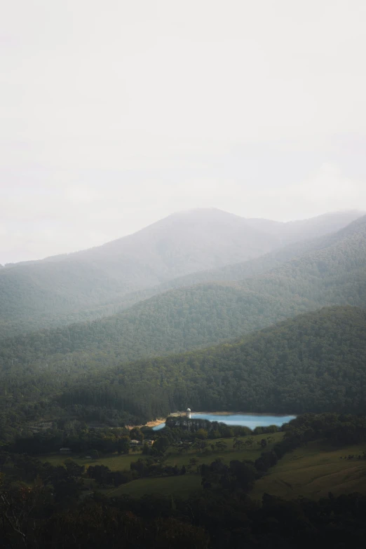 an empty lake in a lush green valley