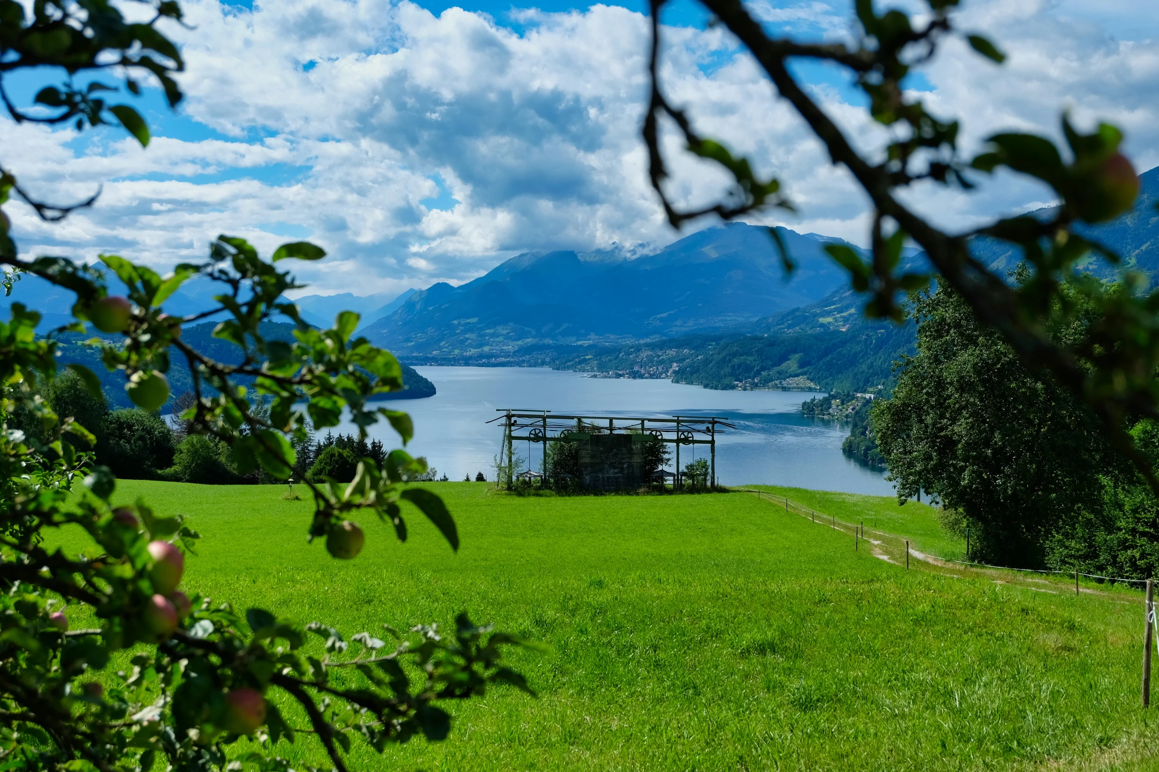 an open field near the ocean and some mountains