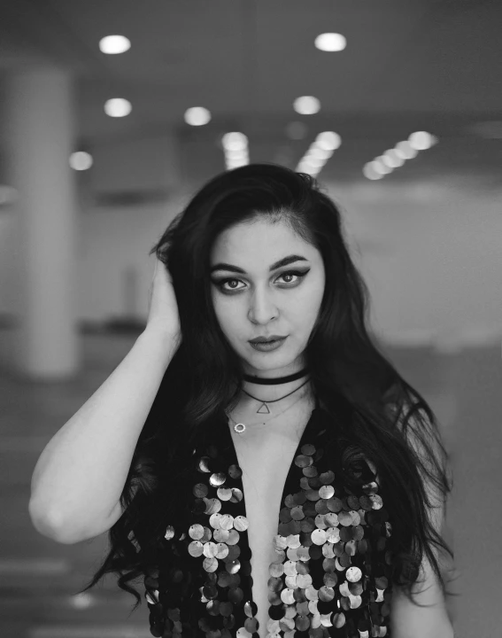 a  poses in an empty building wearing sequins