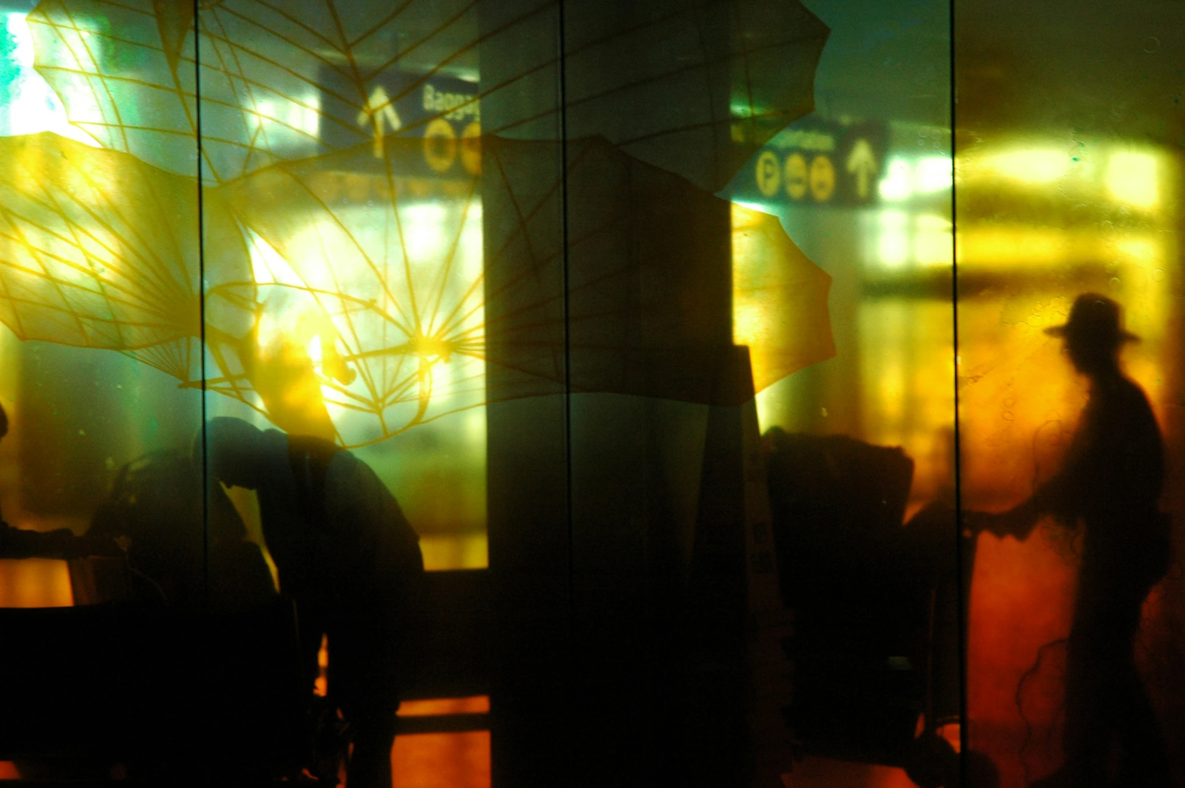 a couple of people that are standing in front of a glass