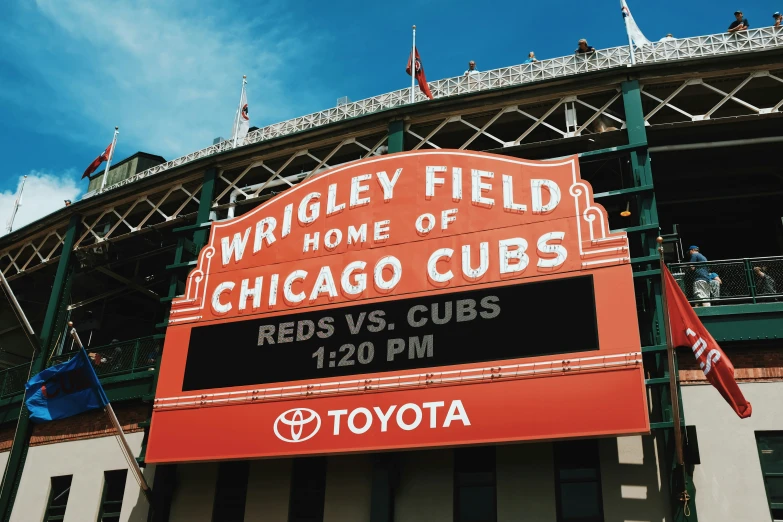 a sign reading wrigley field home of the chicago cubs