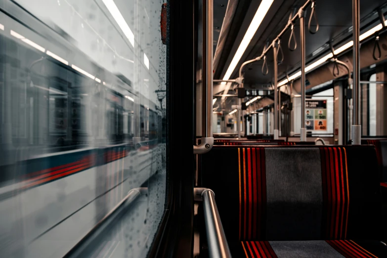 the empty subway car has many seats in it