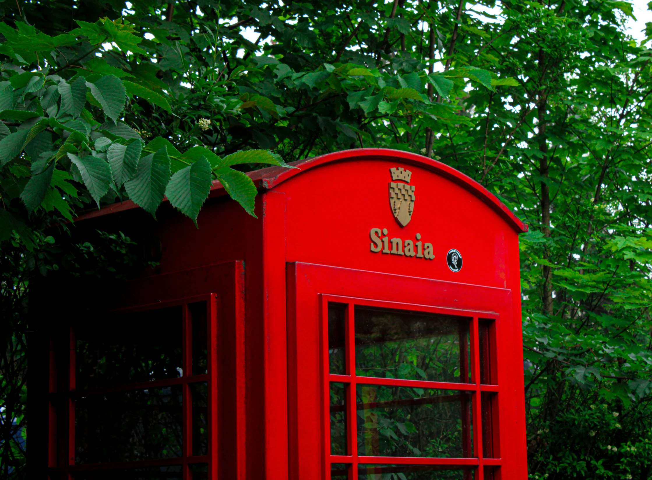 there is a red telephone booth with one door open