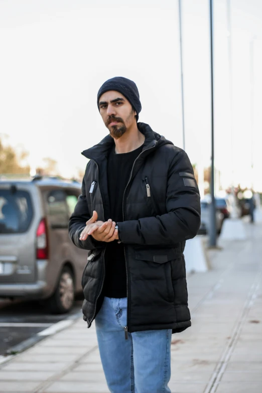 a man wearing a black beanie and a jacket