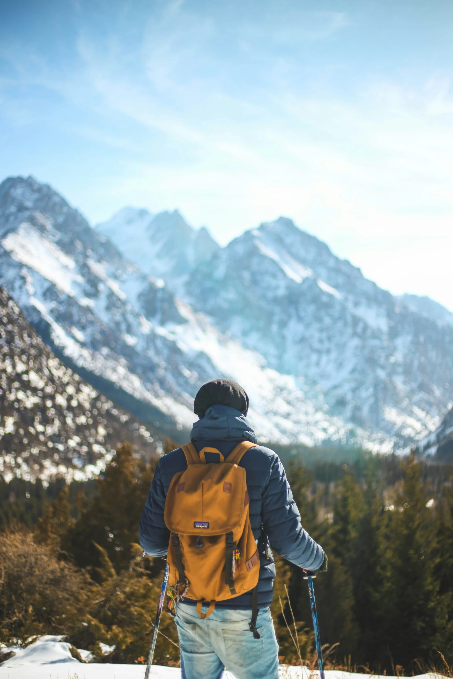 a man with skis that is on a snowy ground