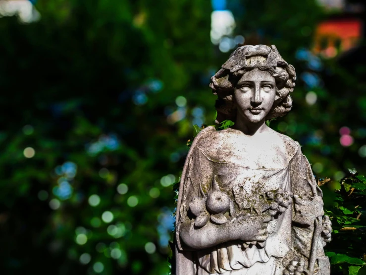 the white statue is in front of a tree