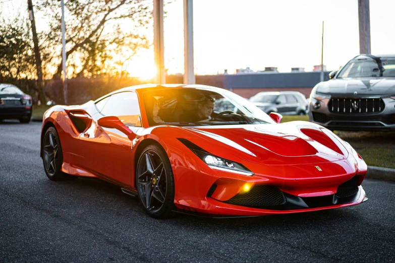 a very nice red ferrari in the middle of a parking lot