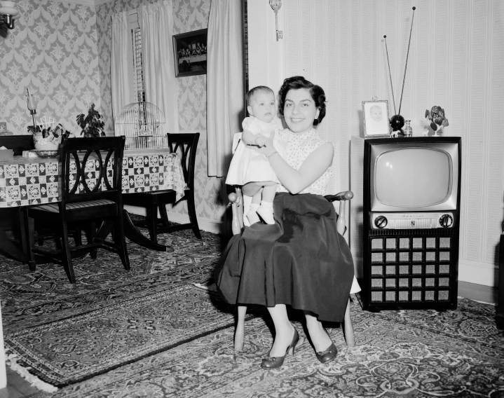 black and white pograph of an old woman holding a baby