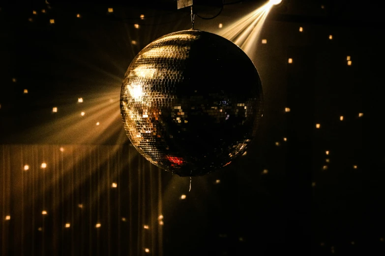 a shiny disco ball hanging from a ceiling