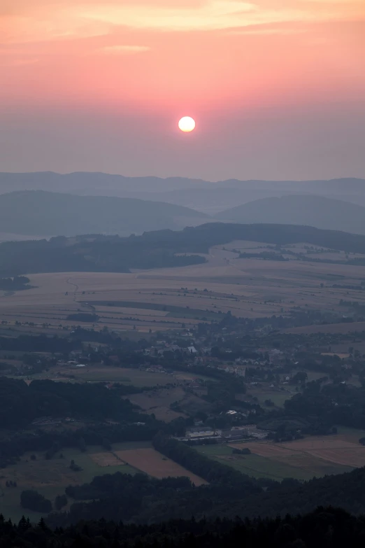 an image of a sun setting on a mountain