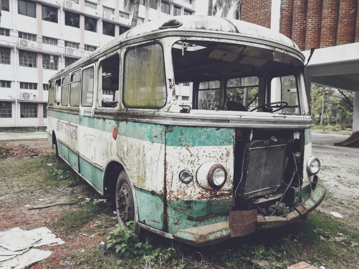 the old abandoned bus is rusting and dying