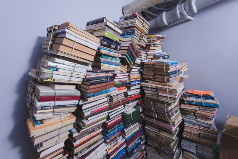 a pile of books in an unfinished room