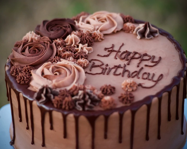 chocolate birthday cake with frosting and flowers