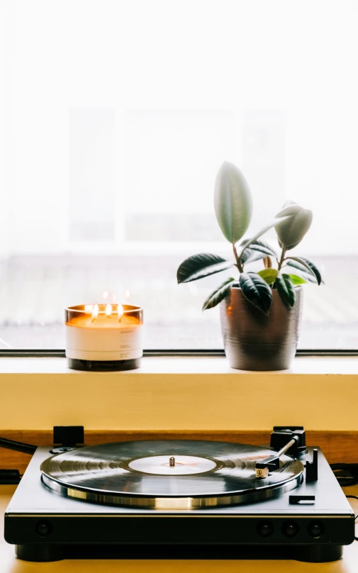 a turntable with a candle in front of it