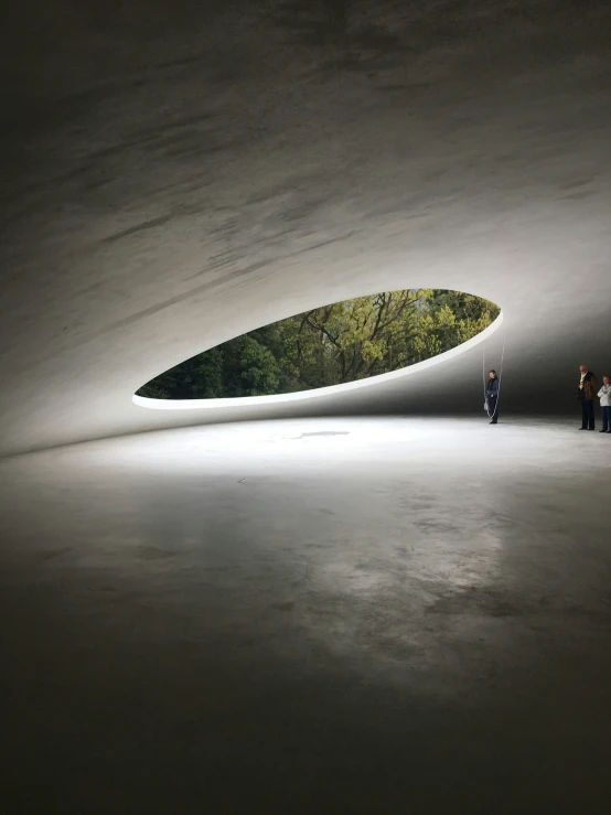 the inside of a building with some people standing in front of it