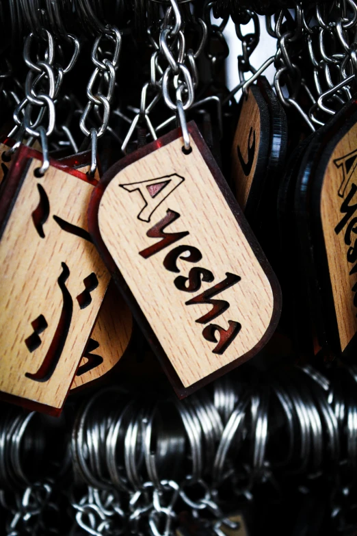 wooden tags with letters hanging from metal chains