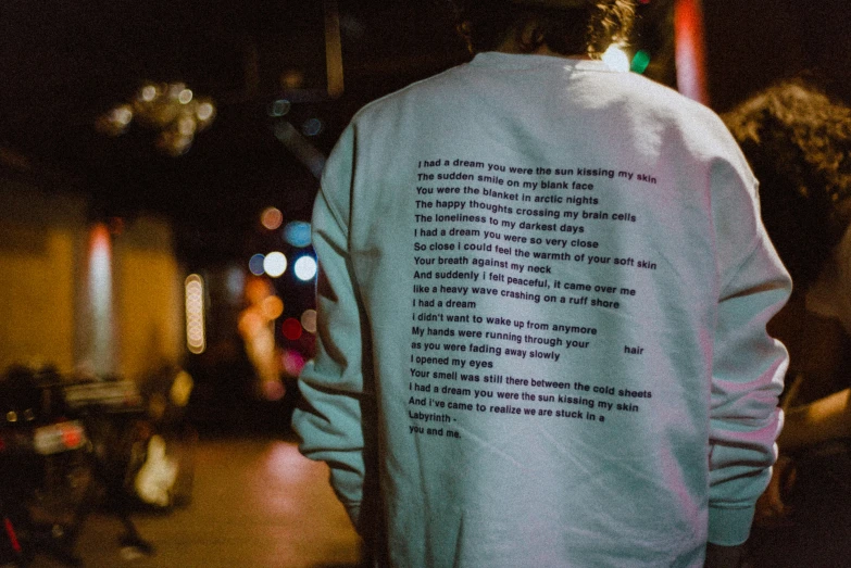 the back of a person wearing a sweatshirt with writing on it