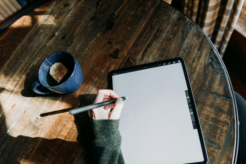 a person on a tablet with a pen