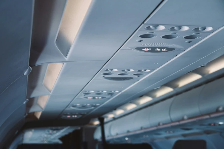 the inside of an airplane with multiple lights