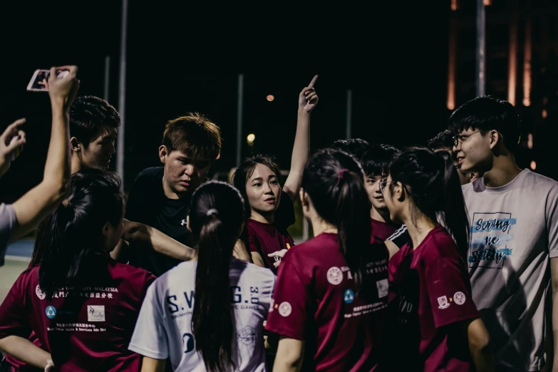 many asian people wearing red uniforms