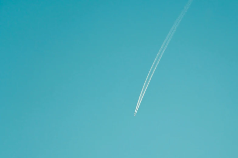 jet contrail high up in the sky with contrails